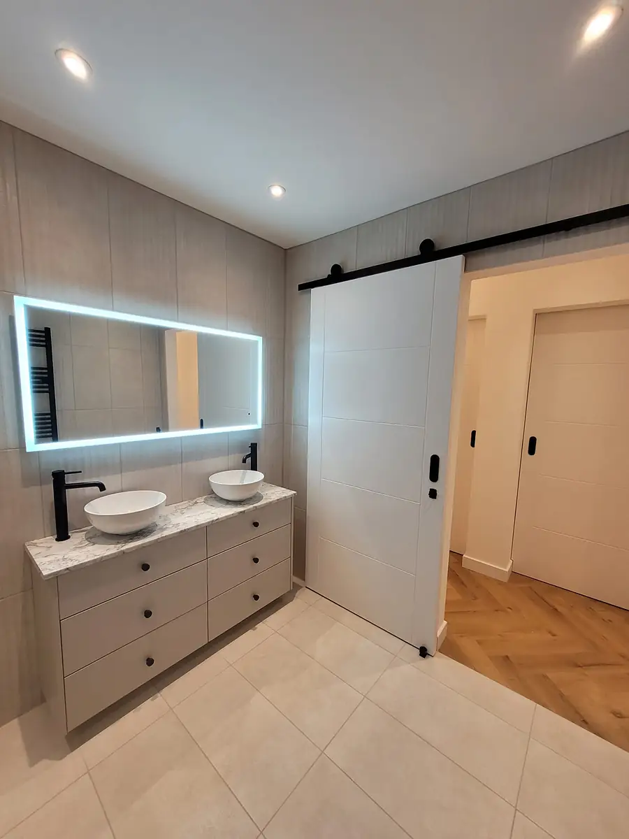 Double vanity with a lit mirror