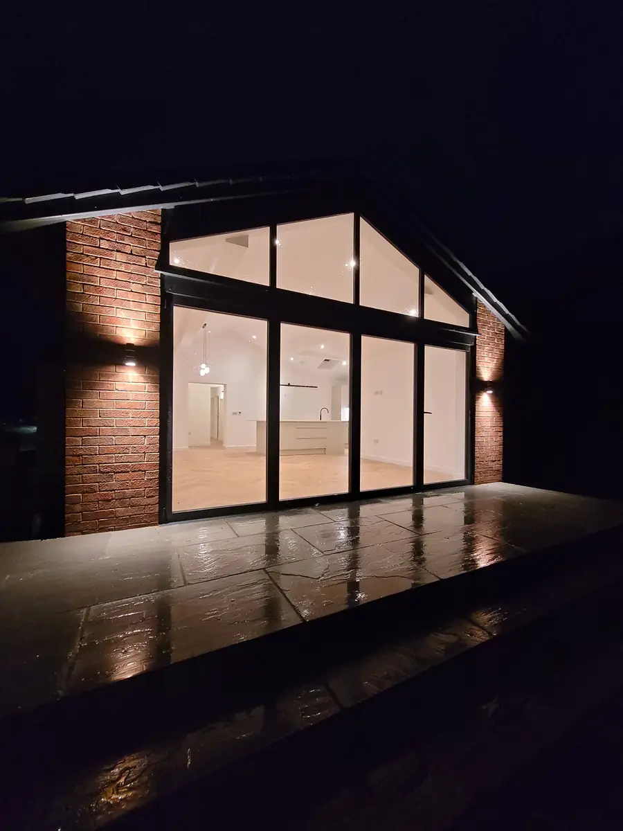Glazed gable at Mallorie Court lit up at night